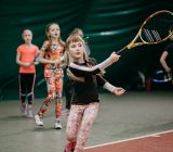 the-young-girl-in-a-closed-tennis-court-with-ball